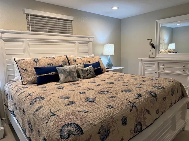 a bedroom with a bed and a mirror