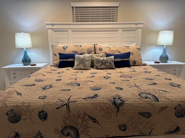 a bedroom with a bed and a lamp