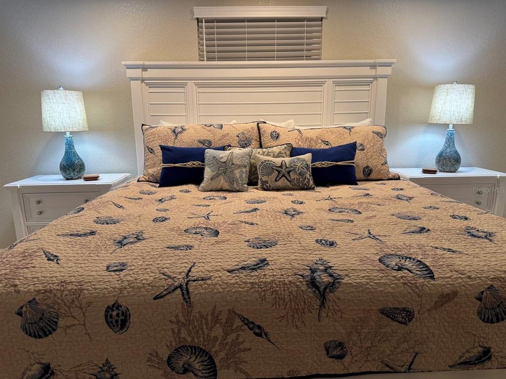 6154 Midnight Pass Road, Unit C15 Sarasota, FL 34242 - Photo 9 of 9 a bedroom with a bed and a lamp