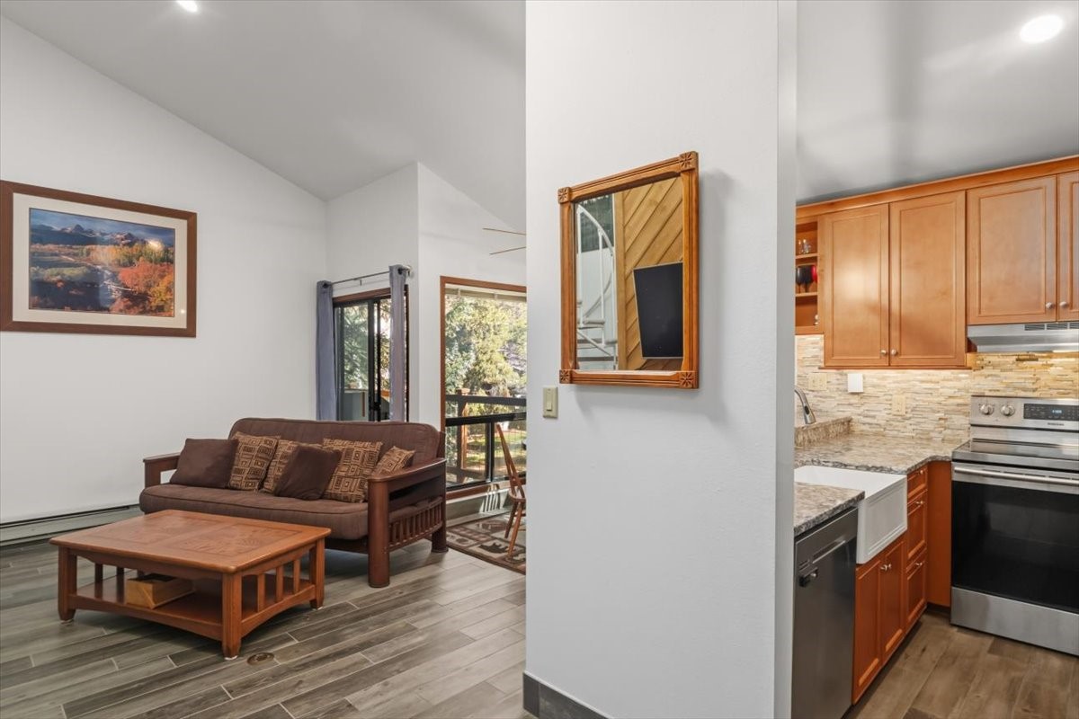 1937 Soda Ridge Road, Unit 1159 Keystone, CO 80435 - Photo 7 of 29 Kitchen featuring stainless steel electric range, light stone countertops, backsplash, dark wood-type flooring, and open shelves