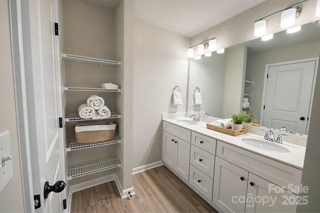 a spacious bathroom with a double vanity sink and a mirror