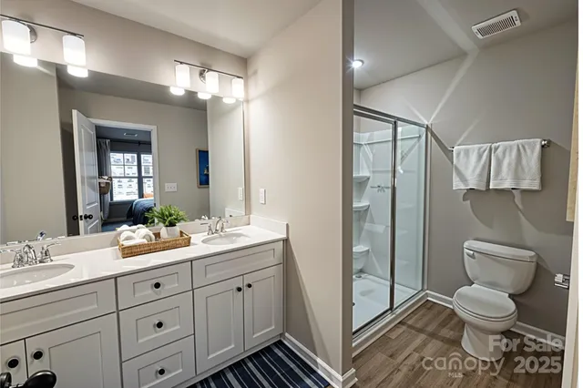 a spacious bathroom with a toilet sink and shower