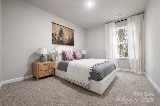 a spacious bedroom with a bed and a couch