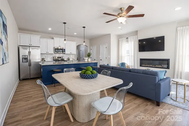 a kitchen with stainless steel appliances kitchen island granite countertop a kitchen island hardwood floor and a sink