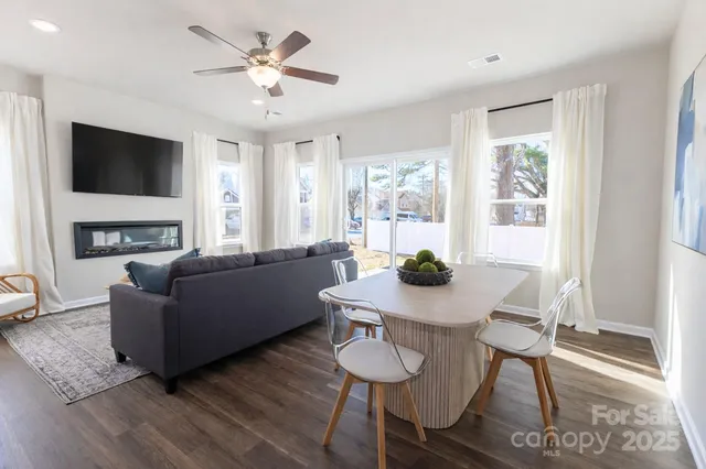 a living room with furniture a fireplace and a flat screen tv