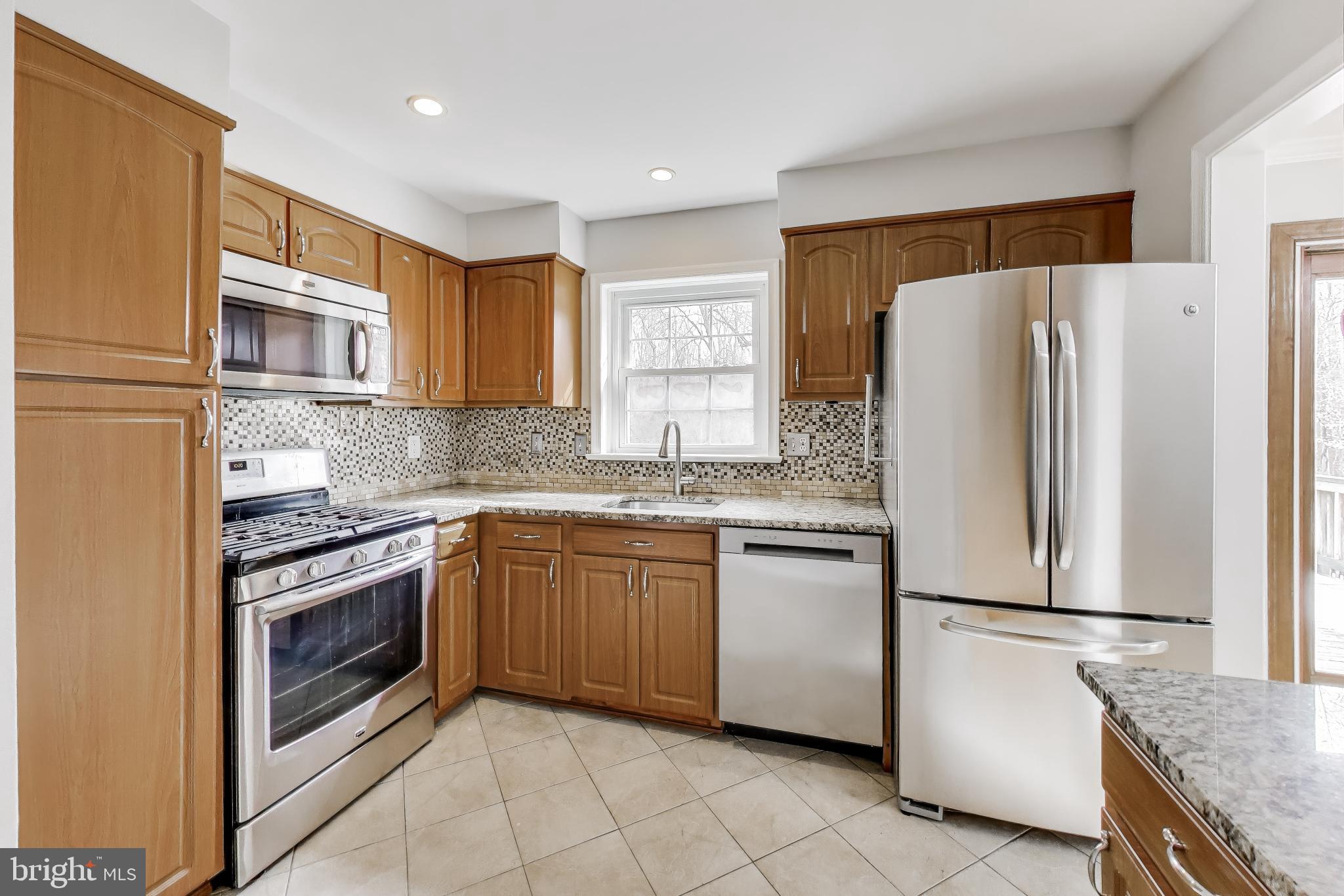 5300 Easton Drive Springfield, VA 22151 - Photo 12 of 60 a kitchen with stainless steel appliances granite countertop a refrigerator sink and stove