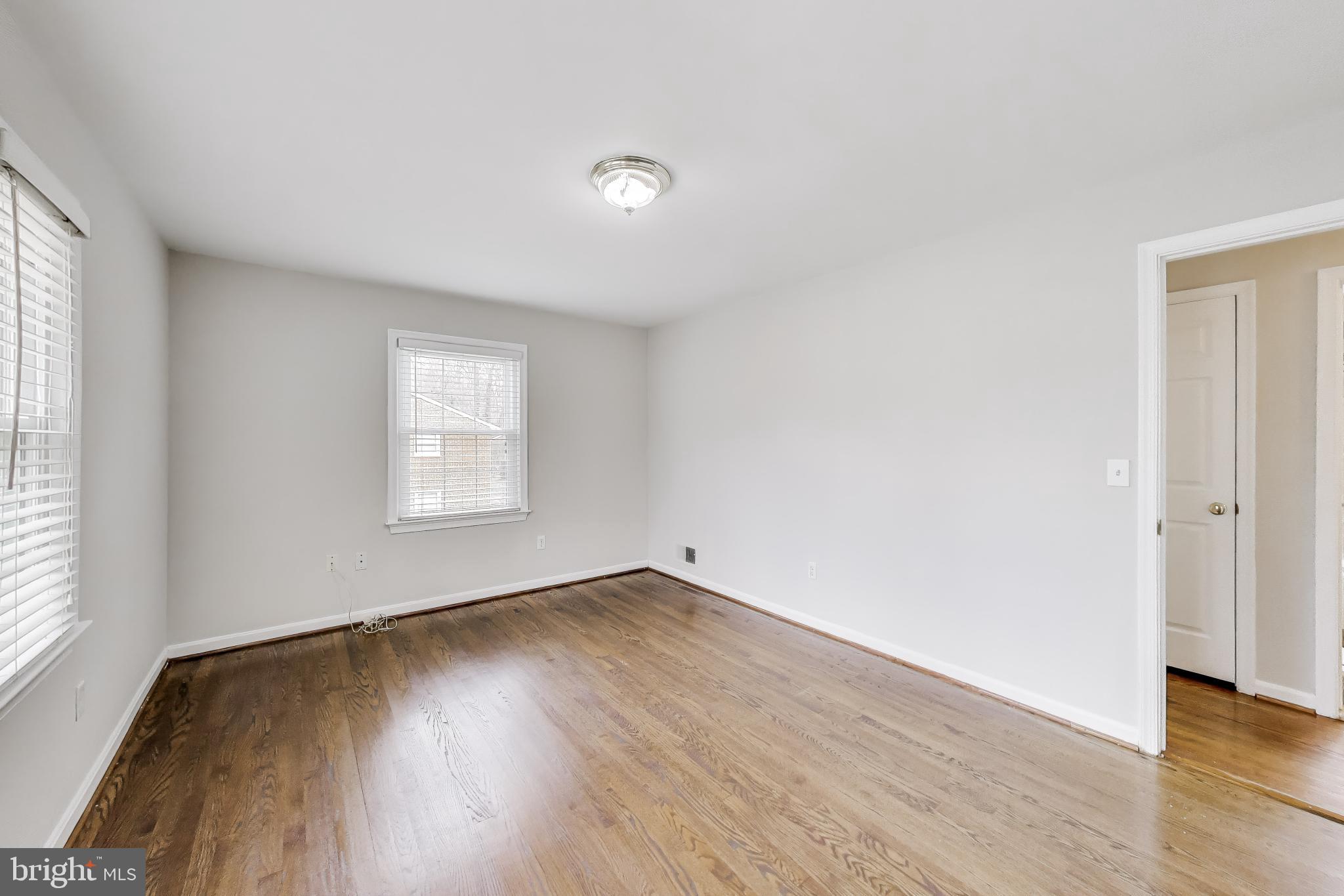 5300 Easton Drive Springfield, VA 22151 - Photo 16 of 60 an empty room with wooden floor and windows