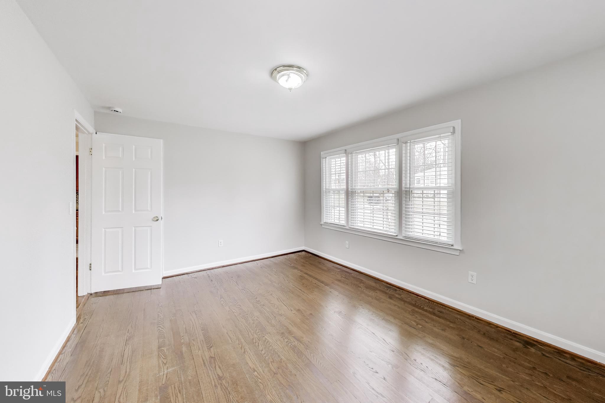 5300 Easton Drive Springfield, VA 22151 - Photo 17 of 60 an empty room with wooden floor and windows