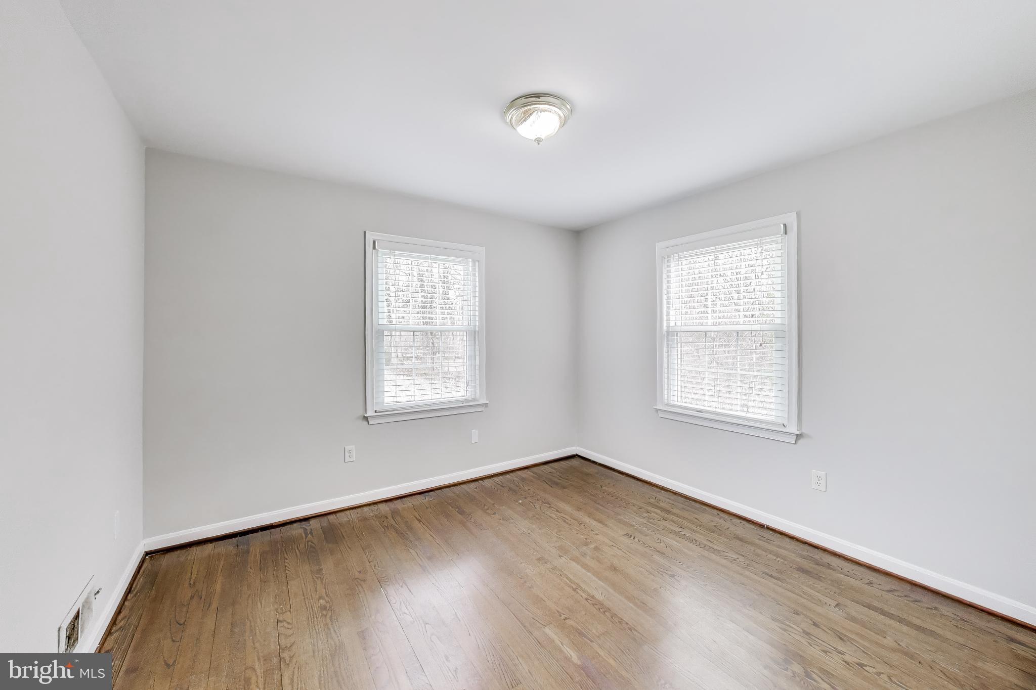 5300 Easton Drive Springfield, VA 22151 - Photo 19 of 60 an empty room with wooden floor and windows