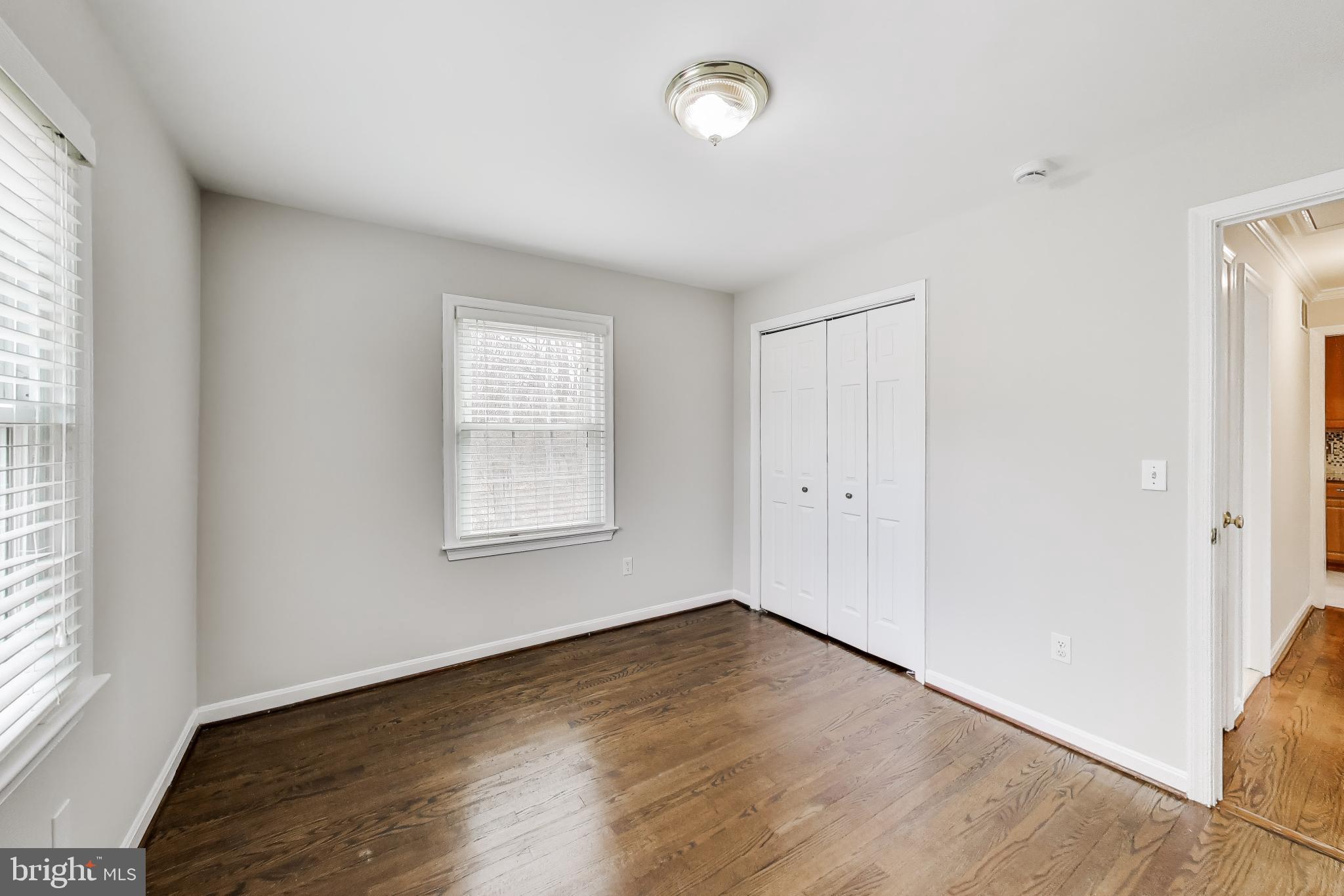 5300 Easton Drive Springfield, VA 22151 - Photo 20 of 60 an empty room with wooden floor and windows