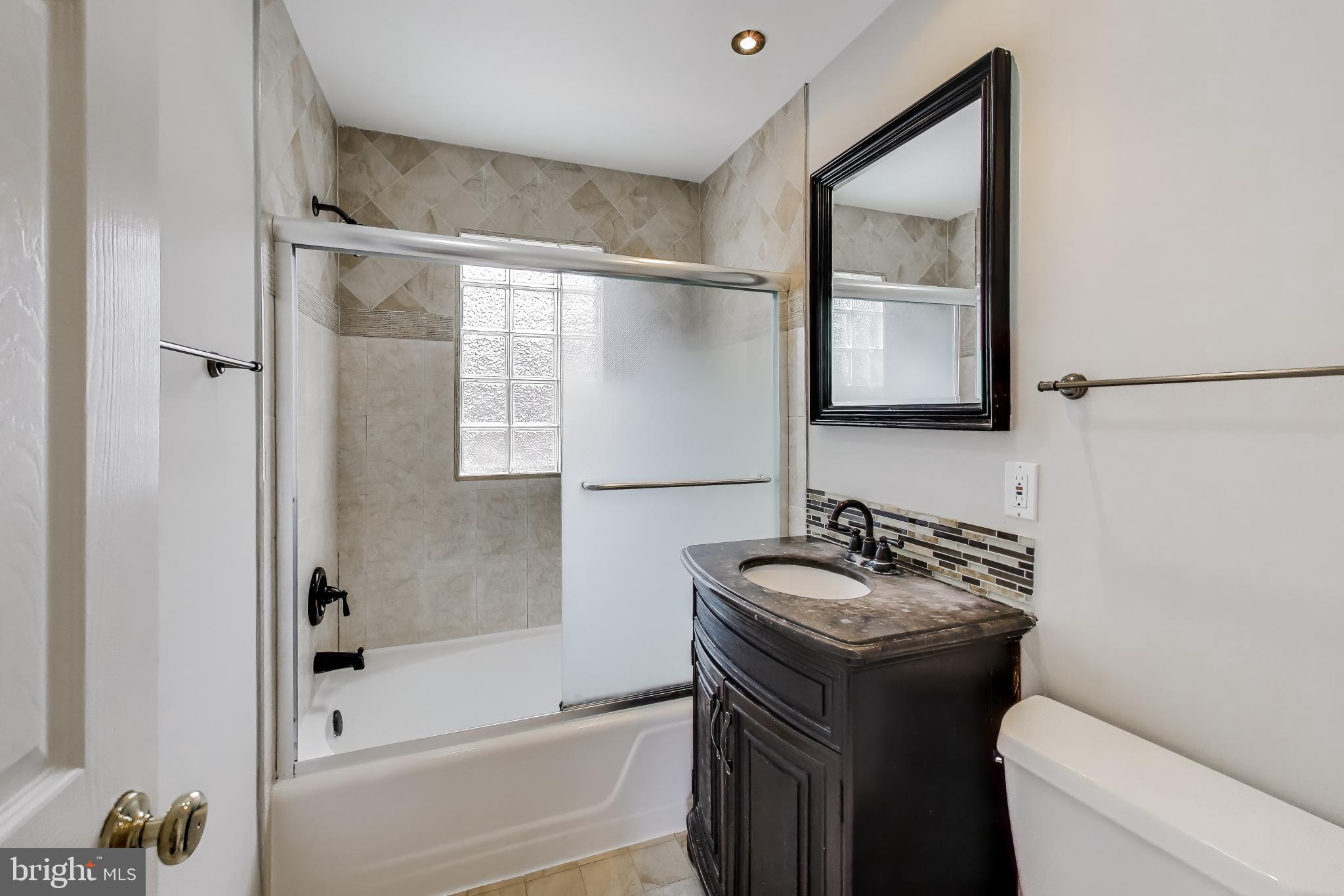 5300 Easton Drive Springfield, VA 22151 - Photo 23 of 60 a bathroom with a sink a toilet and shower
