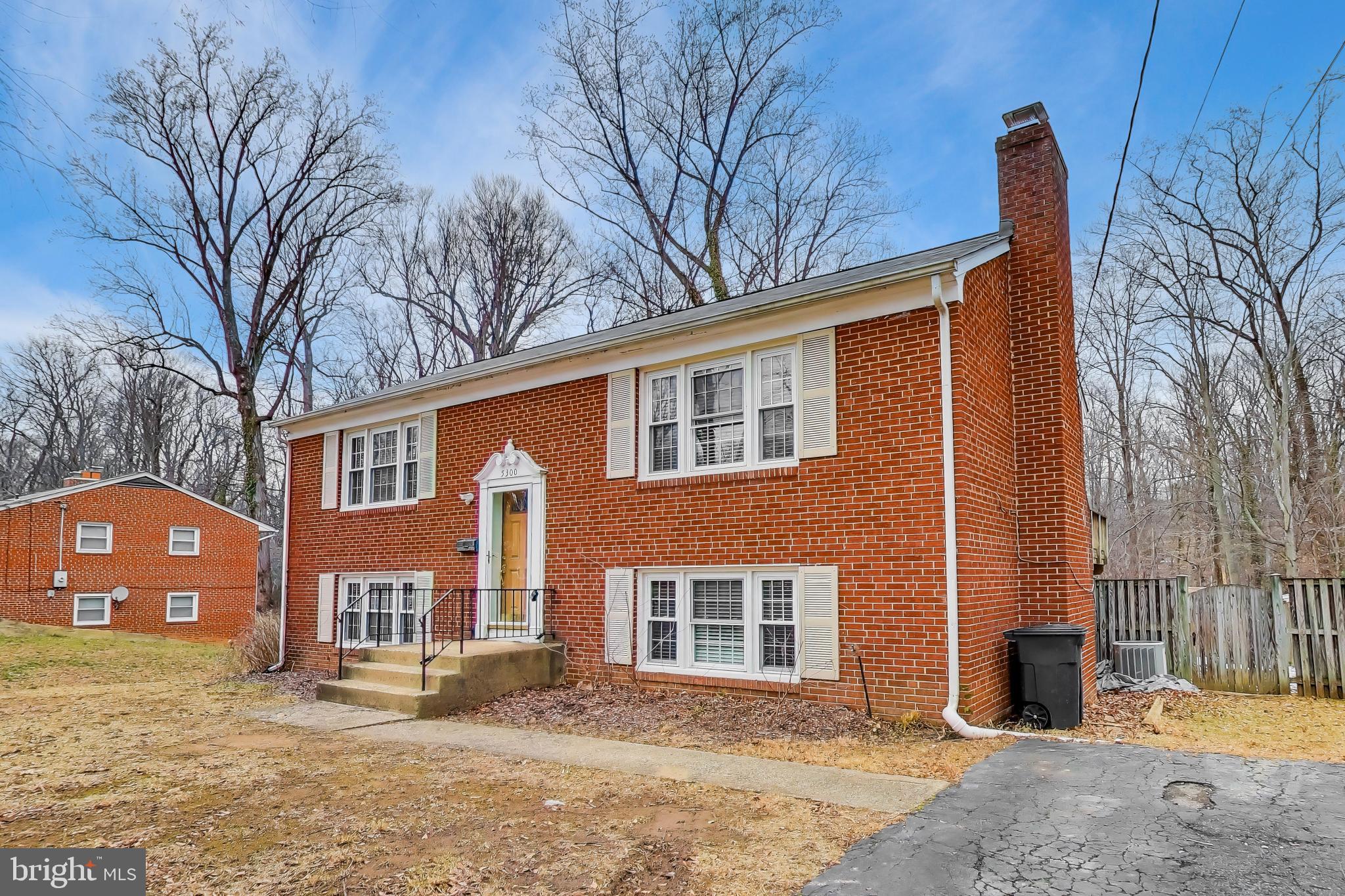 5300 Easton Drive Springfield, VA 22151 - Photo 3 of 60 a front view of a house with a yard and garage