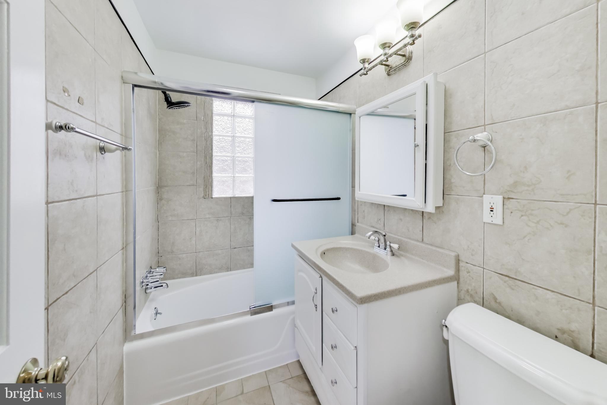5300 Easton Drive Springfield, VA 22151 - Photo 39 of 60 a bathroom with a granite countertop sink toilet and shower