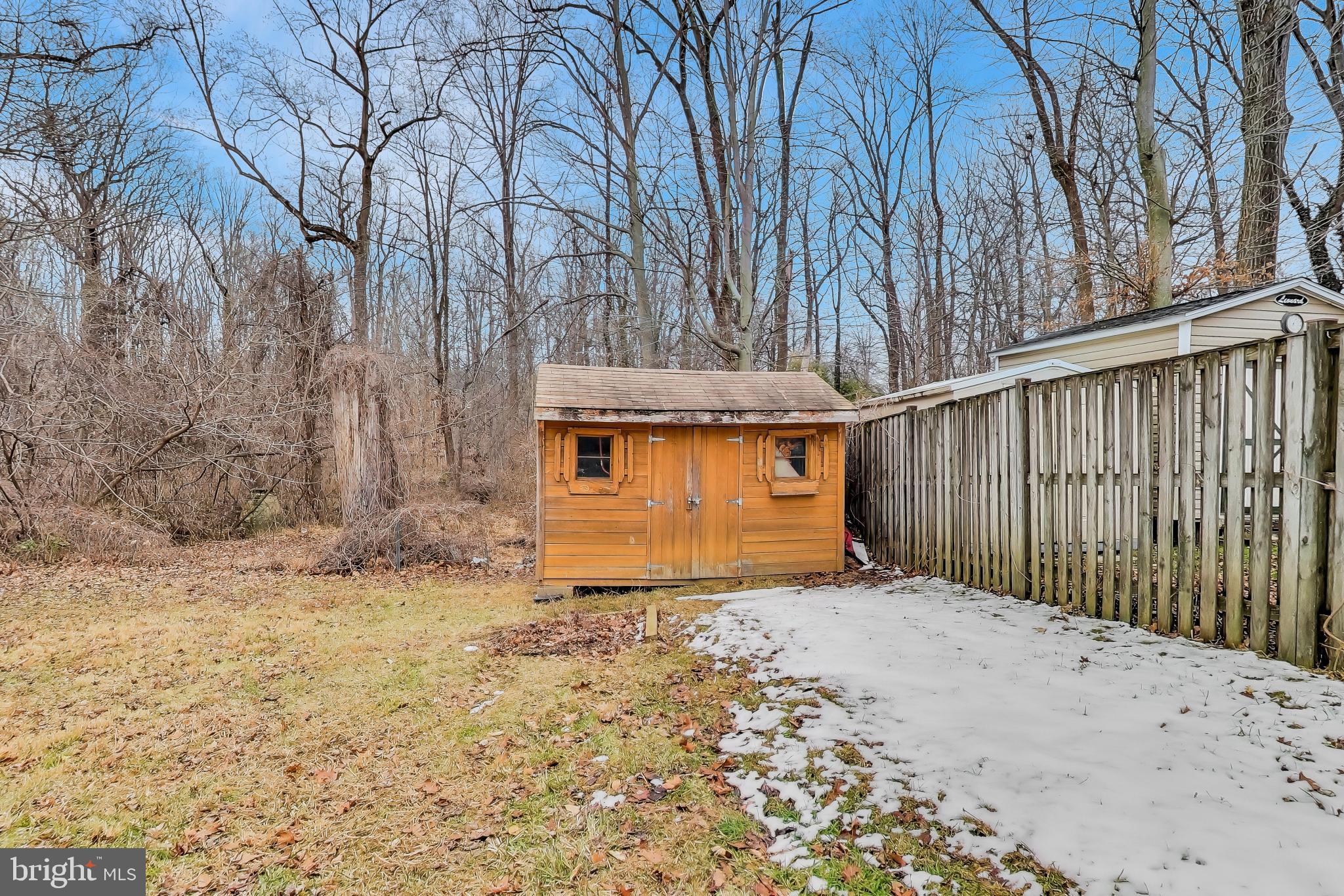 5300 Easton Drive Springfield, VA 22151 - Photo 56 of 60 a view of a house with a large tree and wooden fence