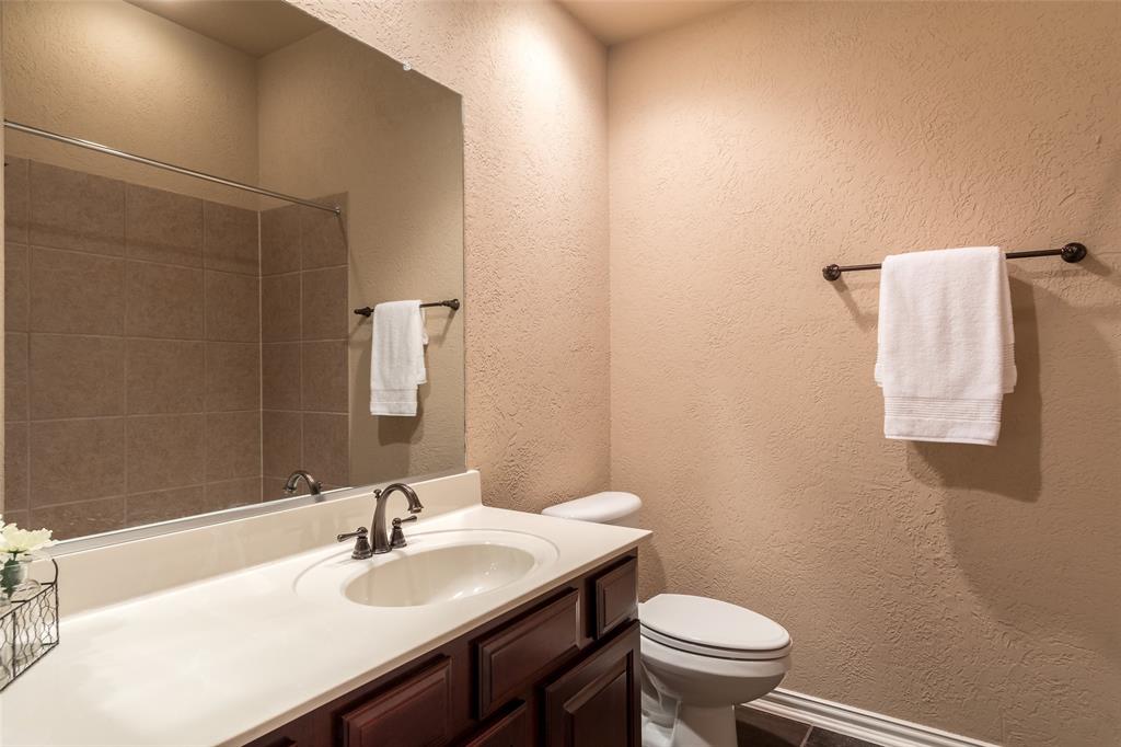 911 Panther Lane Allen, TX 75013 - Photo 17 of 20 a bathroom with a sink a toilet and mirror