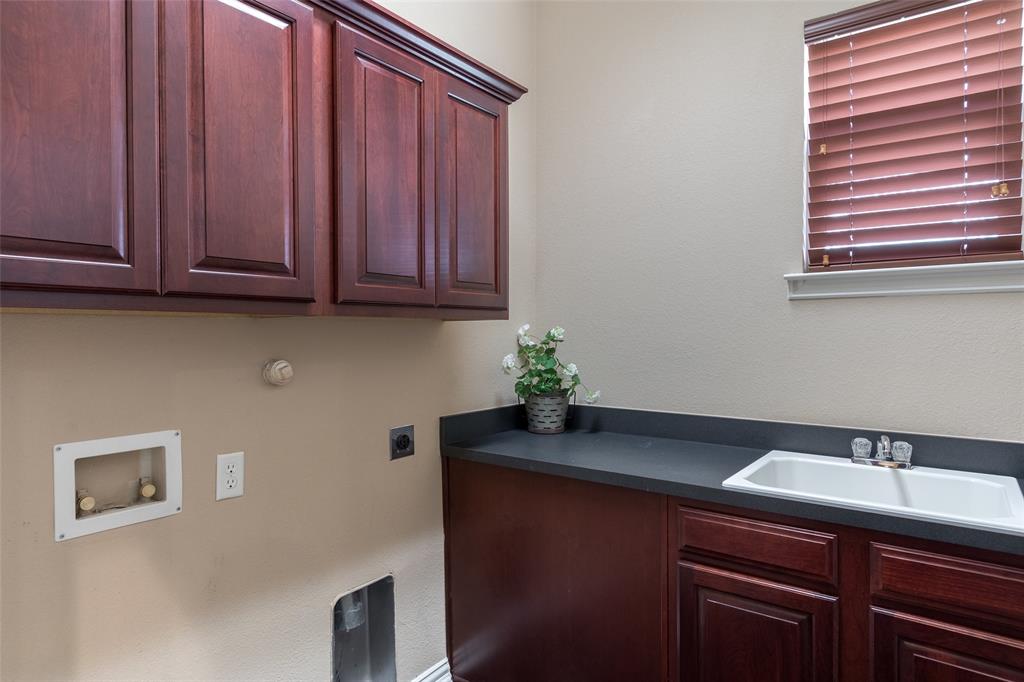 911 Panther Lane Allen, TX 75013 - Photo 19 of 20 a kitchen with a sink and cabinets