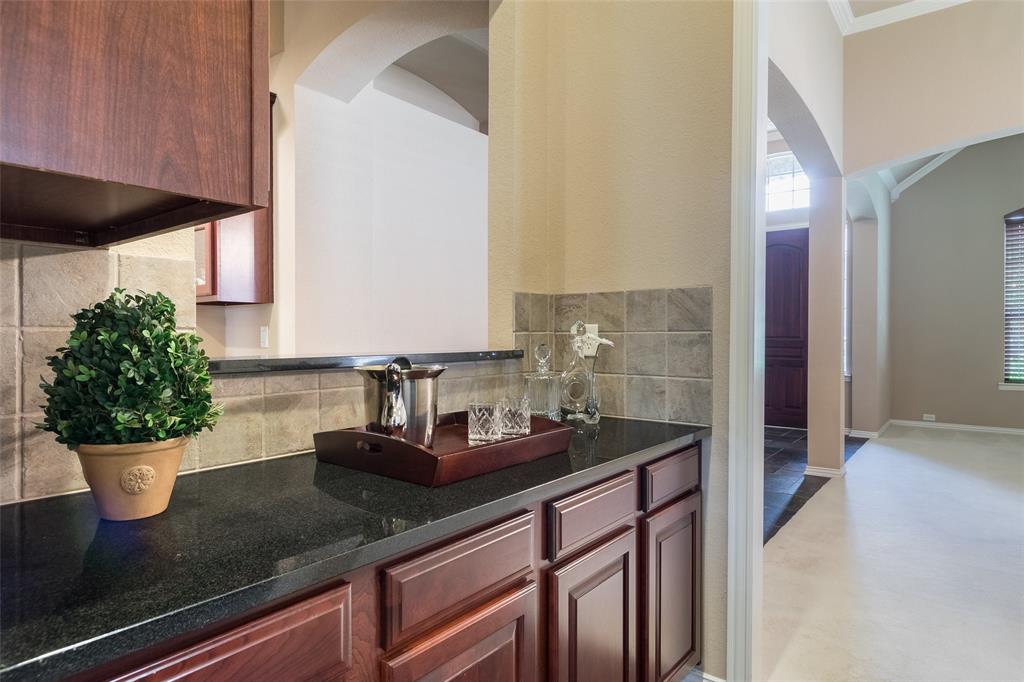 911 Panther Lane Allen, TX 75013 - Photo 6 of 20 a kitchen with a sink a counter and cabinets