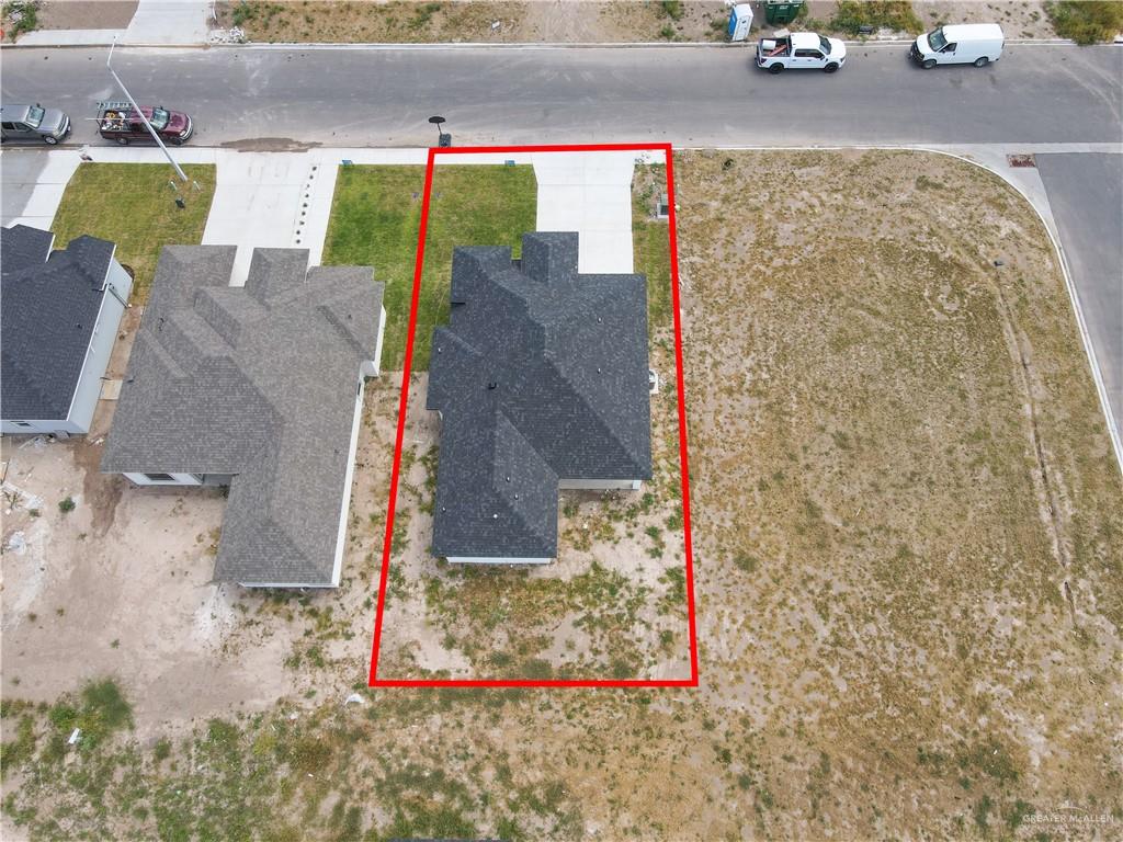 450 Sandy Road Donna, TX 78537 - Photo 15 of 15 Newly constructed residence featuring a dark shingle roof and a concrete driveway