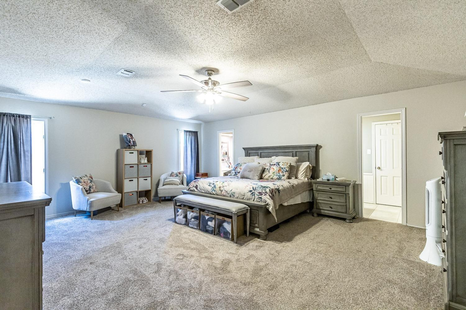 5720 68th Street Lubbock, TX 79424 - Photo 20 of 48 a spacious bedroom with a bed and furniture