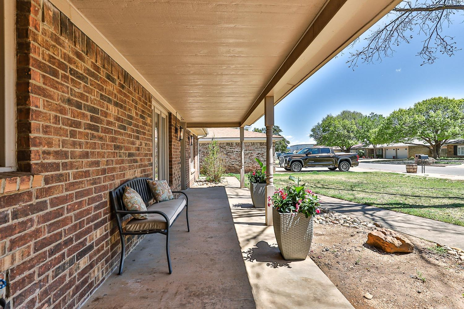 5720 68th Street Lubbock, TX 79424 - Photo 2 of 48 a view of a patio with a dining table and chairs with plants and garden