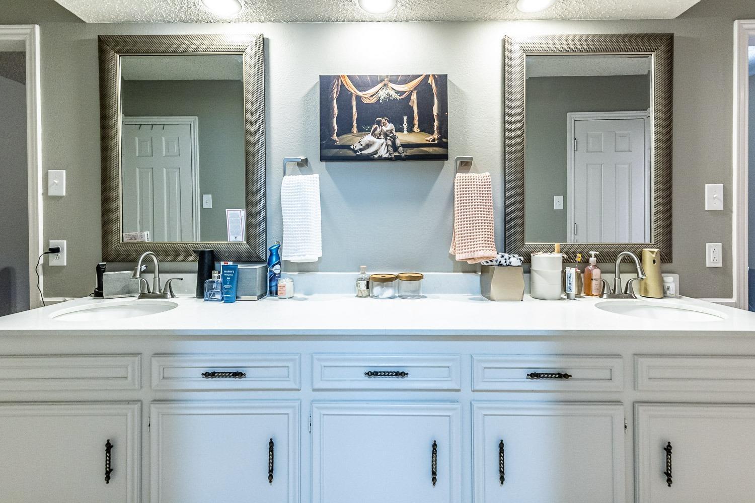 5720 68th Street Lubbock, TX 79424 - Photo 22 of 48 a bathroom with a sink vanity and mirror