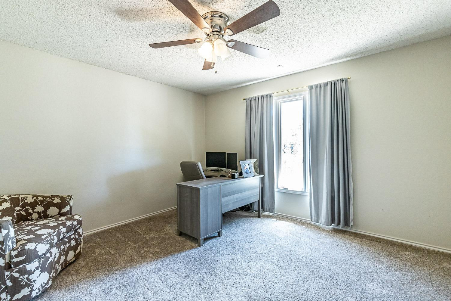 5720 68th Street Lubbock, TX 79424 - Photo 30 of 48 a workspace with furniture and window