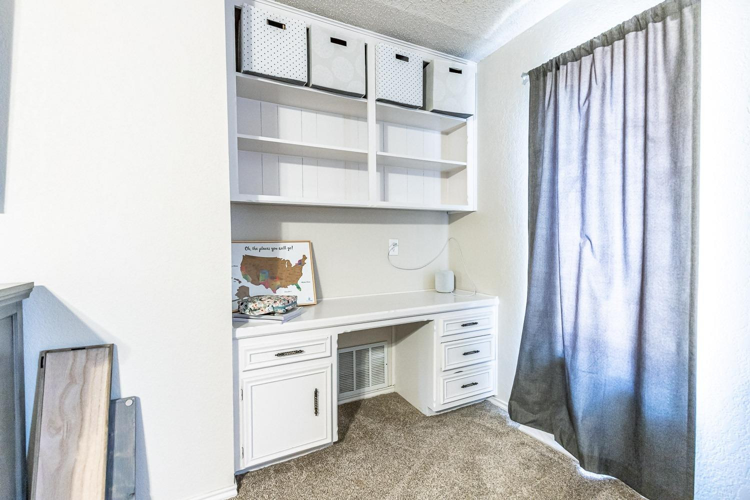 5720 68th Street Lubbock, TX 79424 - Photo 32 of 48 a kitchen with white cabinets and white appliances
