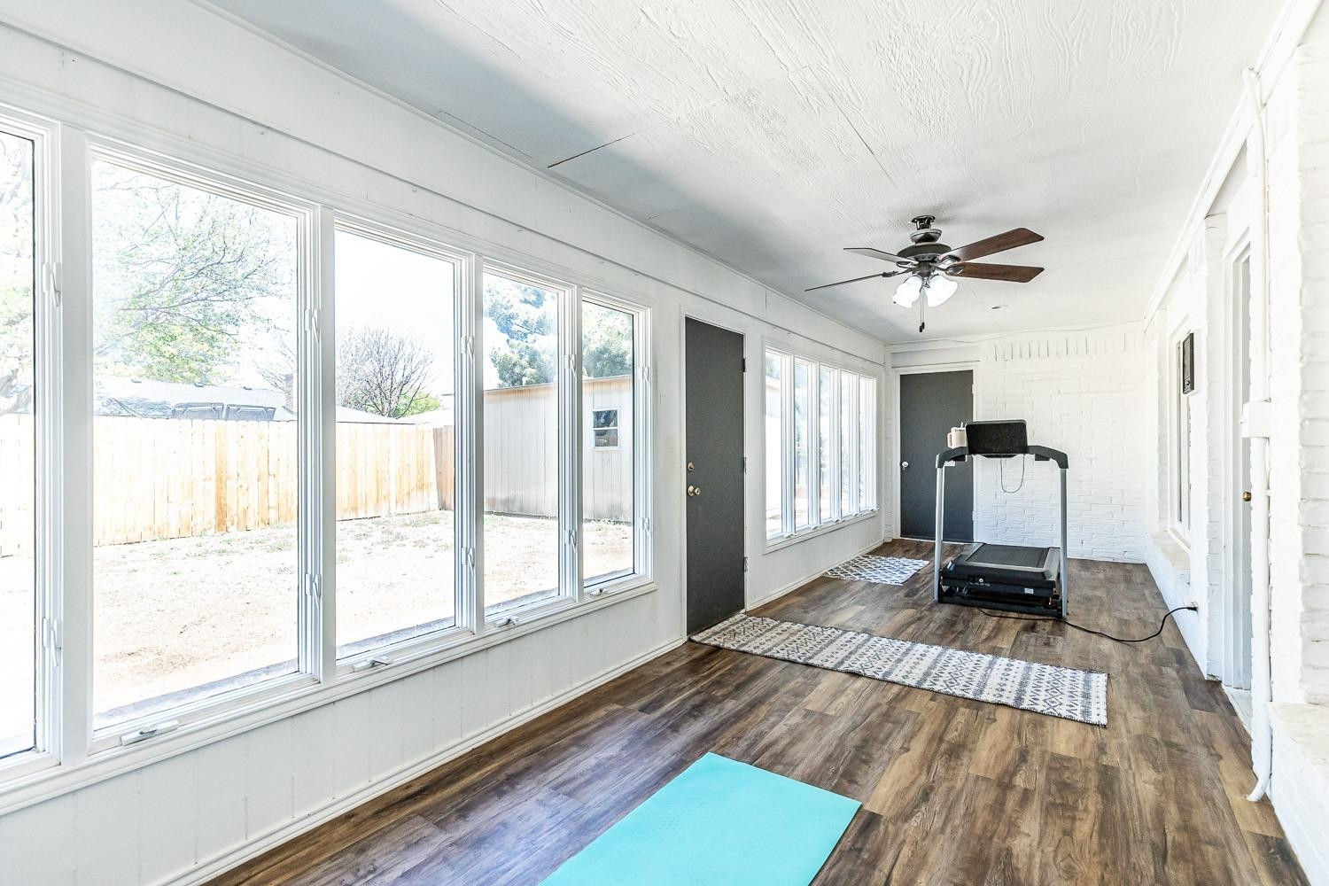 5720 68th Street Lubbock, TX 79424 - Photo 34 of 48 a living room with a balcony furniture and a large window