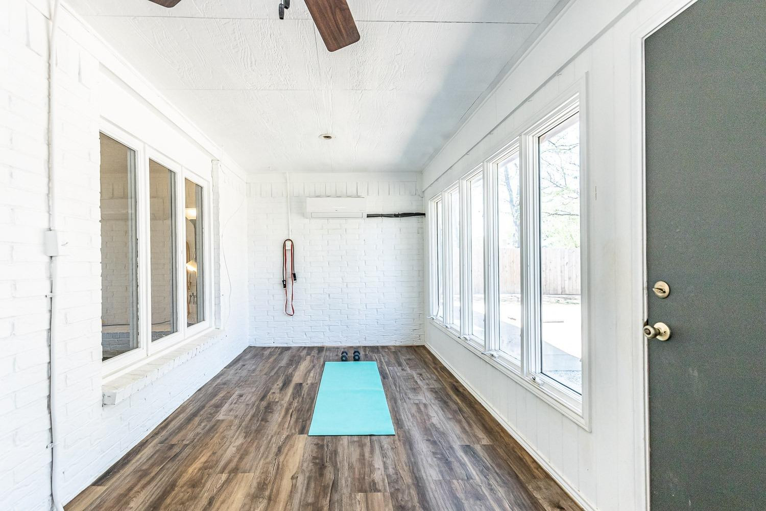 5720 68th Street Lubbock, TX 79424 - Photo 35 of 48 a view of a room with wooden floor and windows