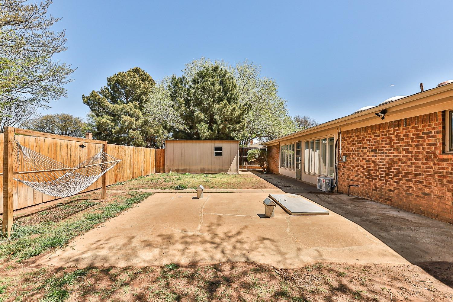 5720 68th Street Lubbock, TX 79424 - Photo 39 of 48 a view of a backyard space with wooden fence
