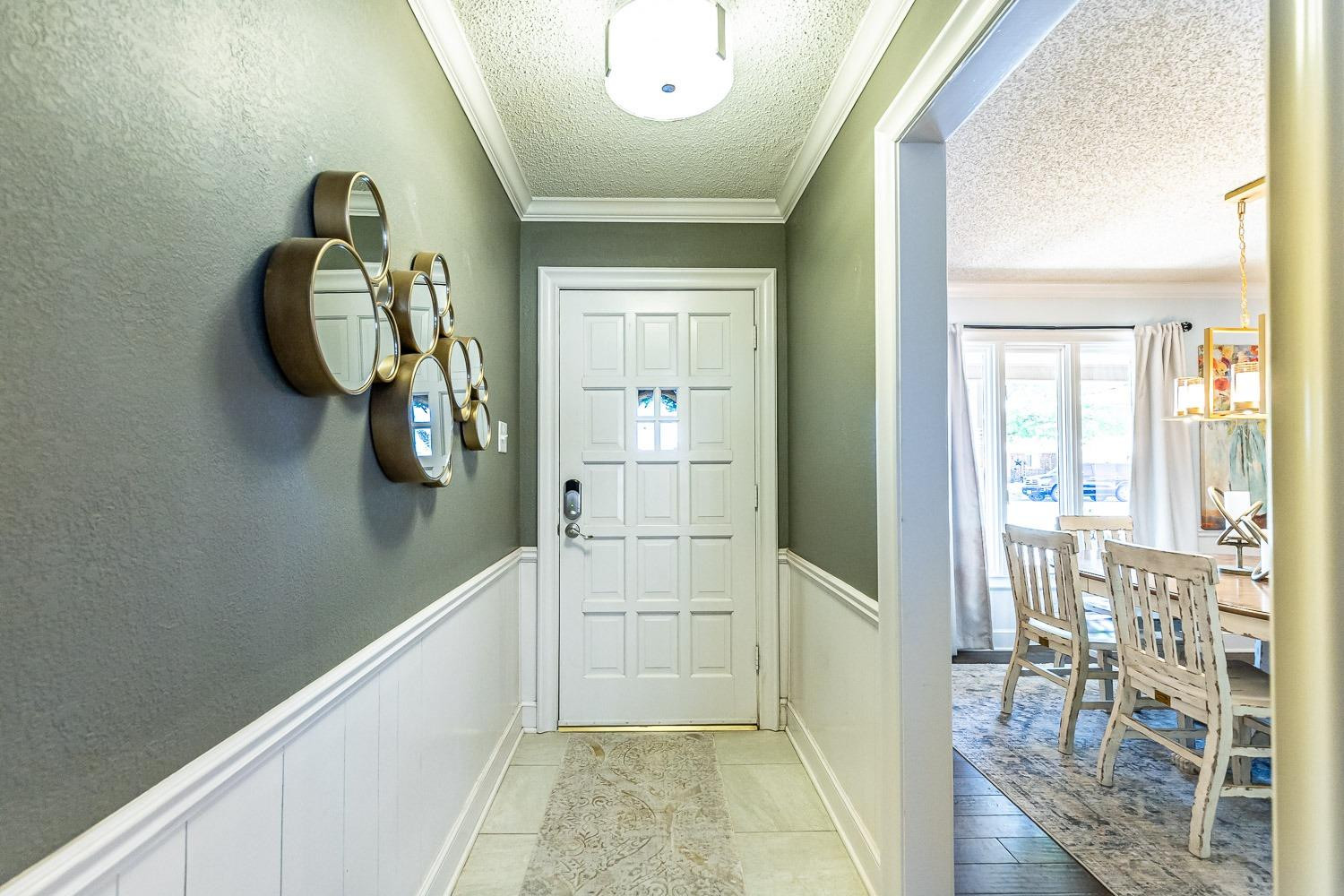 5720 68th Street Lubbock, TX 79424 - Photo 4 of 48 a view of a hallway with wooden floor windows and entryway