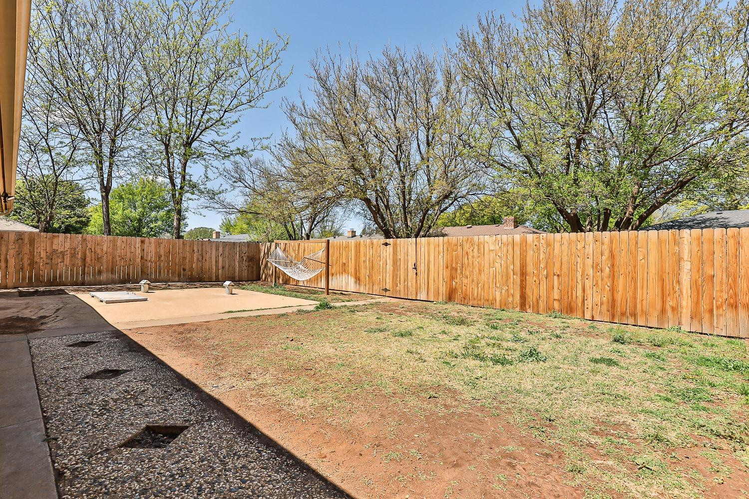 5720 68th Street Lubbock, TX 79424 - Photo 42 of 48 a view of a backyard with wooden fence