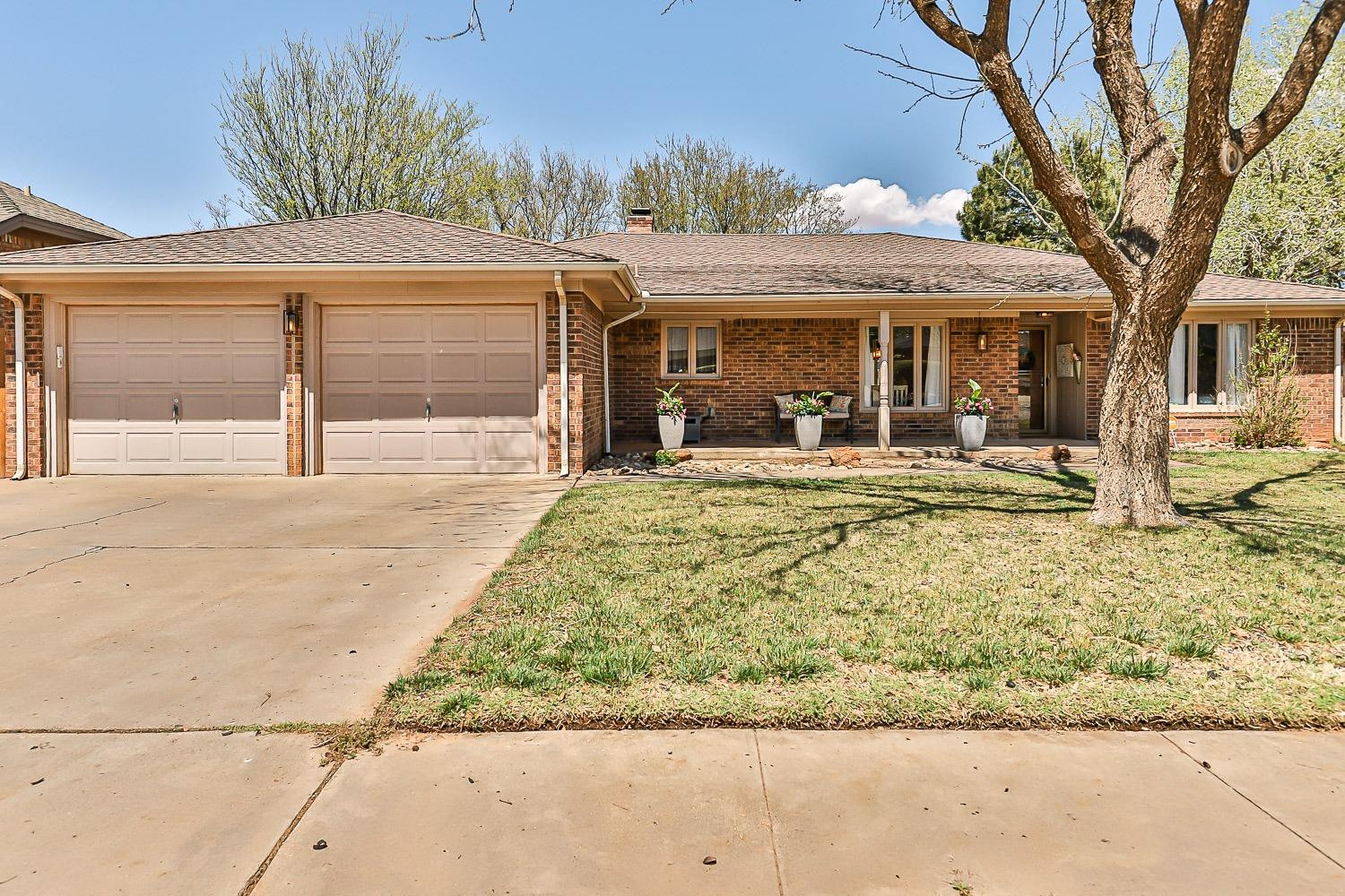 5720 68th Street Lubbock, TX 79424 - Photo 47 of 48 a front view of a house with garden