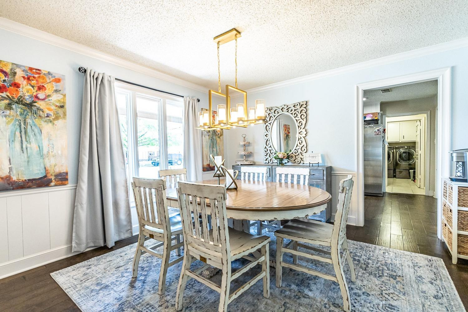 5720 68th Street Lubbock, TX 79424 - Photo 5 of 48 a dining room with furniture a chandelier and wooden floor