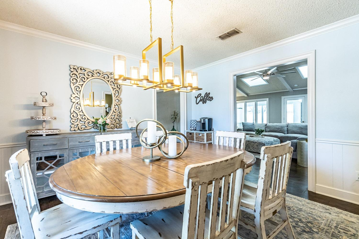 5720 68th Street Lubbock, TX 79424 - Photo 7 of 48 a dining room with furniture a chandelier and wooden floor
