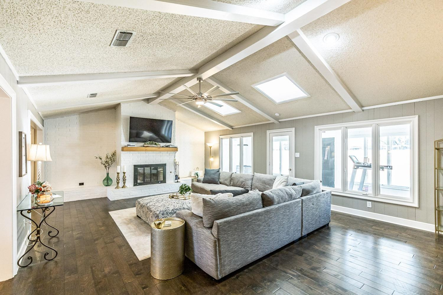 5720 68th Street Lubbock, TX 79424 - Photo 8 of 48 a living room with furniture flat screen tv and a fireplace