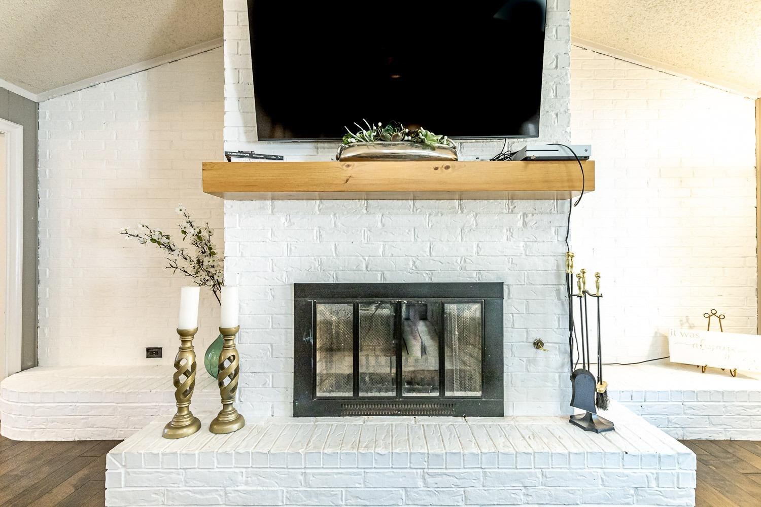 5720 68th Street Lubbock, TX 79424 - Photo 10 of 48 a living room with furniture and a fireplace