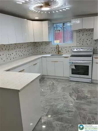 a kitchen with stainless steel appliances cabinets a sink and a stove