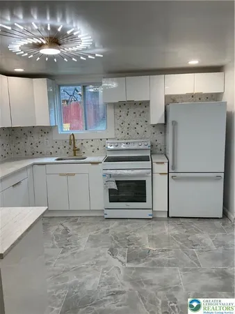 a kitchen with a stove and a refrigerator