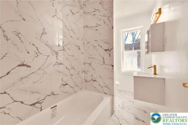 a bathroom with a bathtub and sink