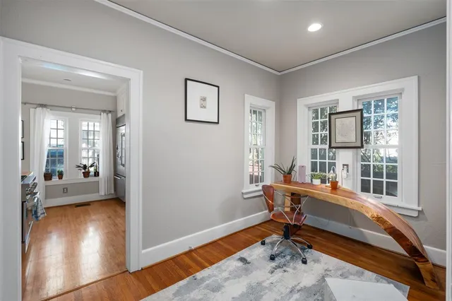 a kitchen with granite countertop a stove and a white cabinets