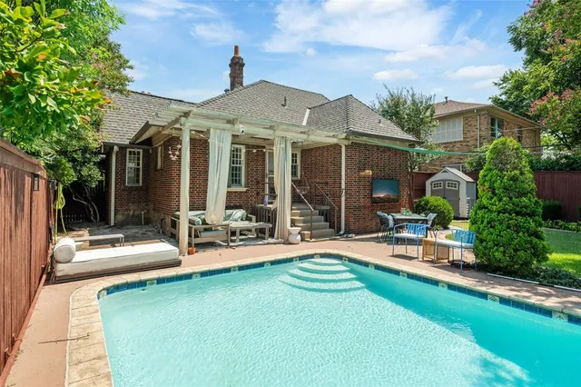 an aerial view of residential house with outdoor space and swimming pool