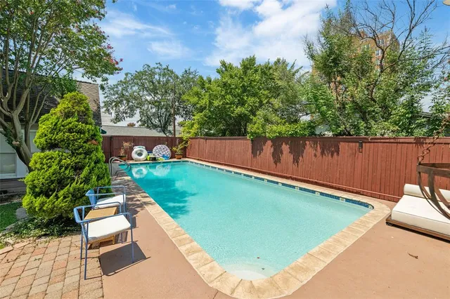 an aerial view of residential house with outdoor space and swimming pool