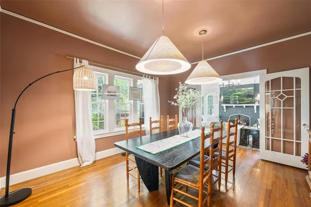 a kitchen with stainless steel appliances white cabinets and wooden floors