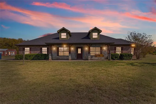 a front view of a house with a garden