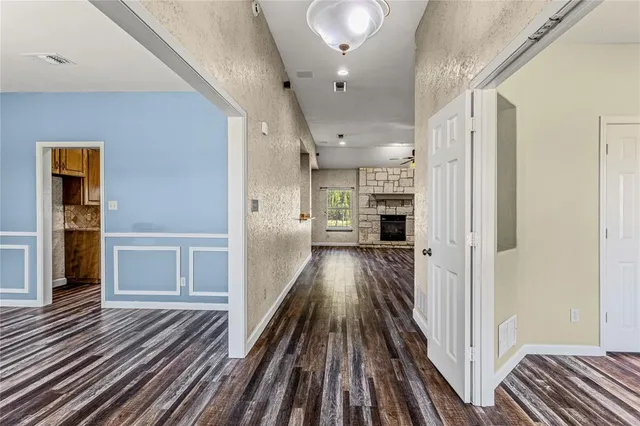 a kitchen with stainless steel appliances granite countertop a sink and wooden cabinets