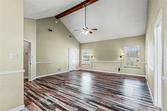 a spacious bathroom with a tub sink and mirror