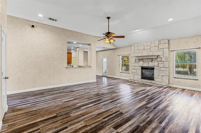 a workspace with wooden floor cabinet and windows