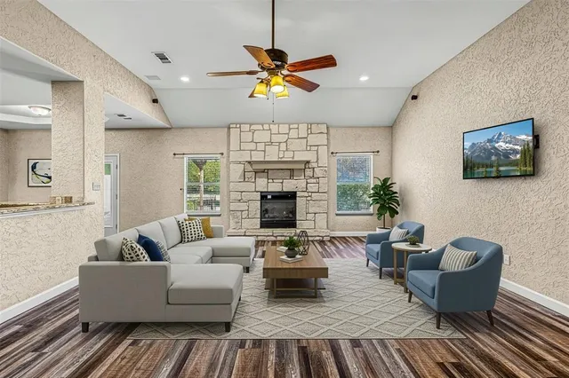 a dining room with furniture a chandelier and wooden floor