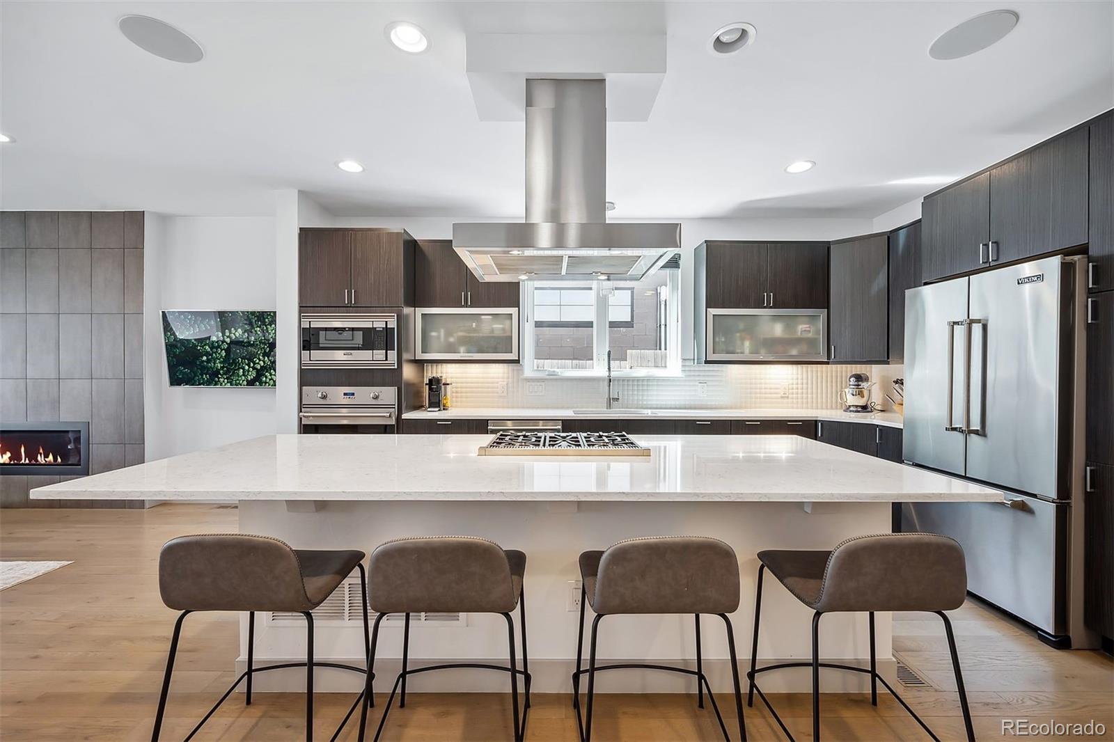 3536 Tejon Street Denver, CO 80211 - Photo 11 of 33 a kitchen with stainless steel appliances kitchen island granite countertop a table and chairs in it